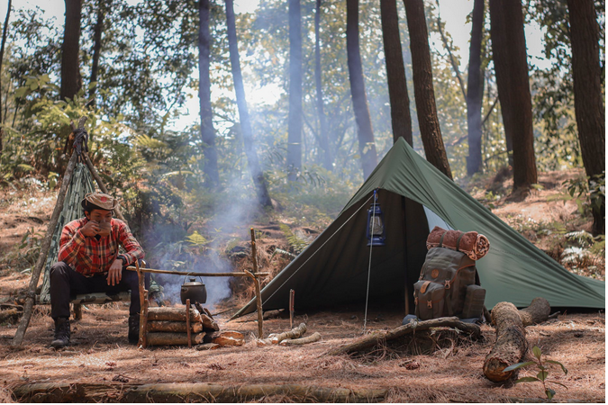 a man in a campsite